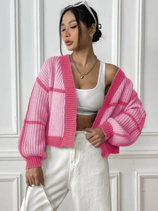 Close-up of pink color-block checkered knit cardigan with loose fit and drop shoulders