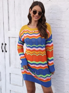 Outdoor shot of a colorful rainbow wave knit dress featuring a vibrant striped hollow design