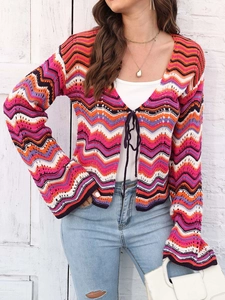Close-up of rainbow chevron crochet cardigan with flared sleeves and lace-up front detail