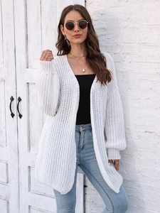 Detail of white chunky knit cardigan texture with drop shoulder and ribbed cuffs