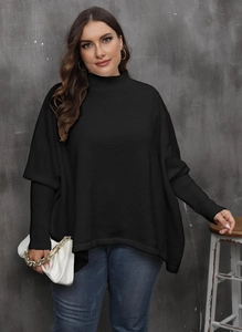 Detail of oversized black batwing sweater with ribbed cuffs and a mock neck for women