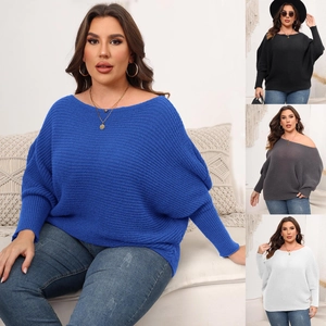 Detail view of baggy batwing sleeves and boat neck design on knitted oversize sweaters