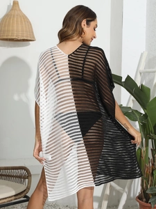 Detail of crochet knit texture on a loose black and white color-block beach cover-up