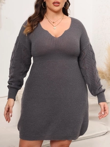 Detail of grey plus size knit dress featuring V-neckline and hollow-out crochet sleeves