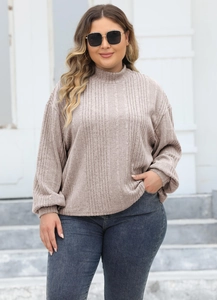 Detail view of oatmeal ribbed knit texture on a plus size mock neck top for women