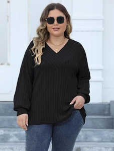 Detail of black V-neck ribbed knit top with criss-cross neckline and lantern sleeves