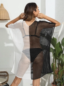 Detail of the back view showing black and white crochet knit texture on a beach cover-up