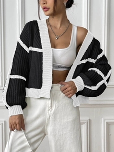 Detail of loose fit knit cardigan with contrast black and white color block stripes