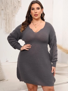 Detailed knit texture and hollow-out floral patterns on the sleeves of the grey dress
