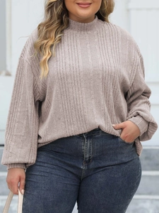 Detail of plus size mock neck top with vertical ribbed texture and snug long cuffs