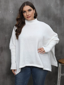 Close-up of white high neck knit sweater featuring loose batwing sleeves and ribbed cuffs
