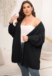 Detail of chunky knit black cardigan with ribbed cuffs and drop shoulder texture