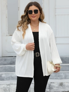 Close-up of white pleated cardigan showing texture of vertical pleats and lantern sleeves