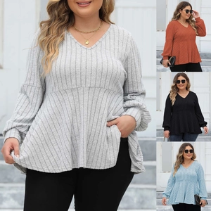 Detail of V-neck ribbed long sleeve peplum top with lantern sleeves in various colors