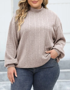 Detailed view of the ribbed knit fabric and high neckline on women's long sleeve top