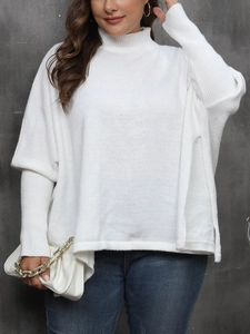 Detail shot of white turtleneck sweater showing fine knit texture and side slit hem design
