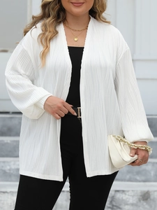 Detailed macro view of white pleated fabric texture on a loose wave stripe cardigan