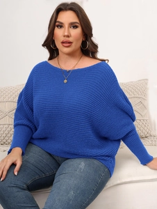 Detail of royal blue oversized knit sweater with batwing sleeves and ribbed texture