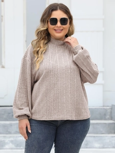 Close-up of vertical ribbed texture on oatmeal high-neck knit sweater for women