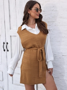 Detail view of knitted vest dress with high side slit and matching waist belt tie