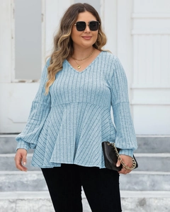 Macro detail of the light blue ribbed knit texture and stylish V-neck on a plus size top