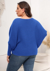 Macro detail of royal blue ribbed knit texture and wide batwing sleeve of this sweater