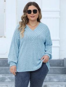 Detail of plus size light blue ribbed knit sweater featuring a cross V-neck design for women