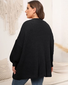 Detailed back view of chunky knit black cardigan with oversized lantern sleeves and soft texture