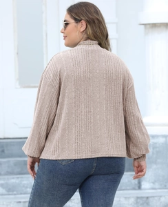 Back view of women's beige ribbed knit top with a high collar and loose drop shoulder design