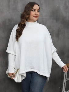 Macro detail of white mock neck sweater showing ribbed cuffs and soft knit texture