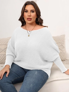 Detail of white knit sweater showing textured batwing sleeves and ribbed cuff texture