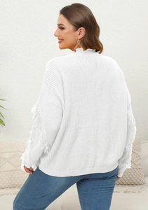 Detail of white knit sweater featuring long decorative fringe sleeves and high collar
