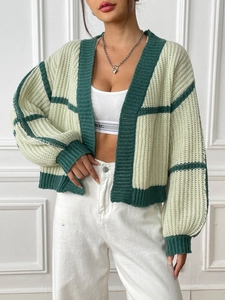 Detail of contrast stripe knit cardigan showing rib-knit cuffs and loose drop shoulder style