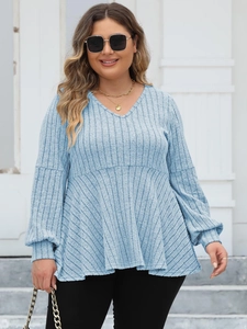 Detail of light blue plus size V-neck ribbed top with lantern sleeves and peplum hem