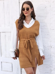 Detail of ginger knit vest dress with V-neckline, drawstring waist and side slit accents