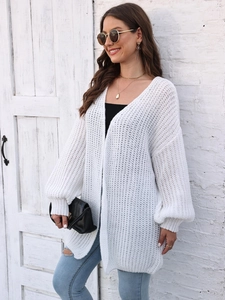 Women's white chunky knit cardigan featuring lantern sleeves and relaxed fit style