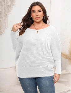 Detail of white oversized off-shoulder knit sweater with horizontal ribbed texture and batwing sleeves