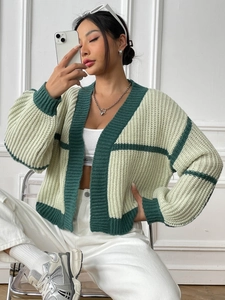 Detail of a women's color-block knit cardigan with green ribbed trim and V-neckline