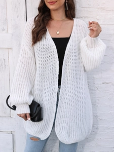 Detail of white chunky knit cardigan featuring lantern sleeves and a relaxed casual fit