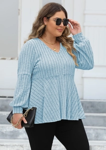 Detail view of light blue V-neck knit top with vertical rib texture and flared doll hem