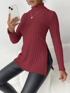 Detail view of burgundy turtleneck sweater with ribbed texture and high side slit design