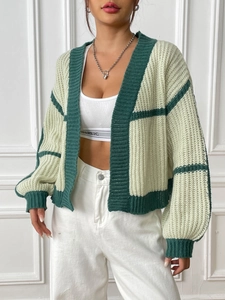 Detail of color-block knit cardigan with rib-knit cuffs and cream green checkered pattern