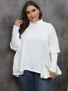 Detail of white oversized mock neck knit sweater with ribbed cuffs and soft texture