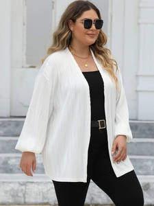 Close-up of white pleated cardigan fabric texture and flowy design on woman