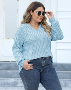 Close-up detail of light blue ribbed knit V-neck cross front long sleeve sweater top