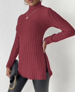 Detail view of burgundy turtleneck knit sweater with vertical ribbing and side slit design
