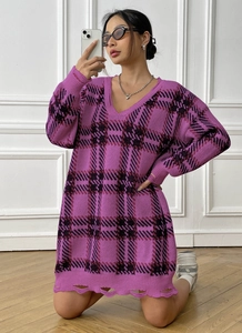 Detail view of V-neck plaid knit dress featuring distressed hem and oversized purple check