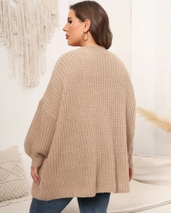 Detail of chunky knit texture and loose fit design on women's beige oversized cardigan