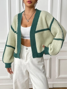 Detailed knit texture of green color-block cardigan with ribbed cuffs and drop shoulder
