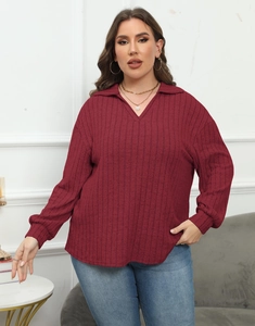 Detail of wine red ribbed knit polo shirt featuring long sleeves and casual fit style